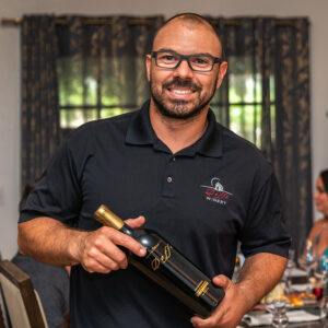 Damian Doffo holding a bottle of wine