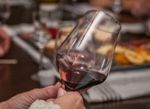 A guest looking at a glass of wine