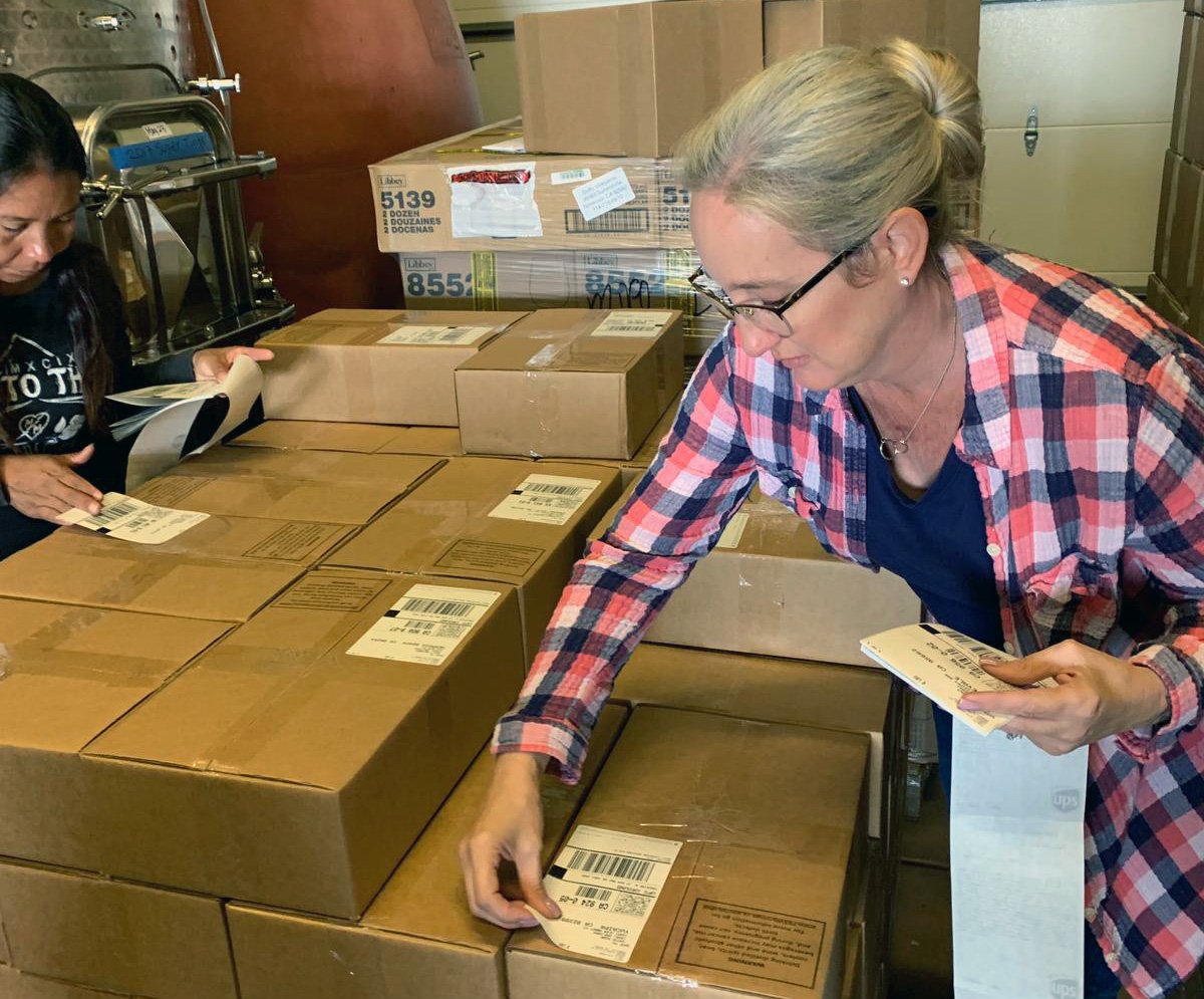 Gayla preparing wine club orders for shipment.