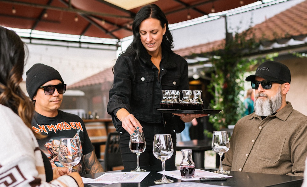 Customers enjoying a wine tasting at a table at Doffo Winery